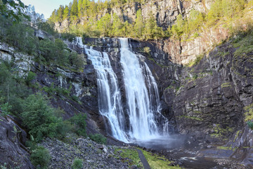 Fototapeta na wymiar Skjervsfossen norwegian landmark high powerful cascade waterfall. Nature travel clean falling water horizontal landscape