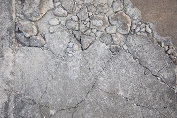 A close-up shot of the road with fragmented stones,where the cracks and crazed lines have occurred, shows the surface details visible. It is beautiful and suitable for making the background.