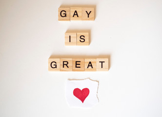 Gay is Great word tiles LGBTQ+ with a heart and a white background
