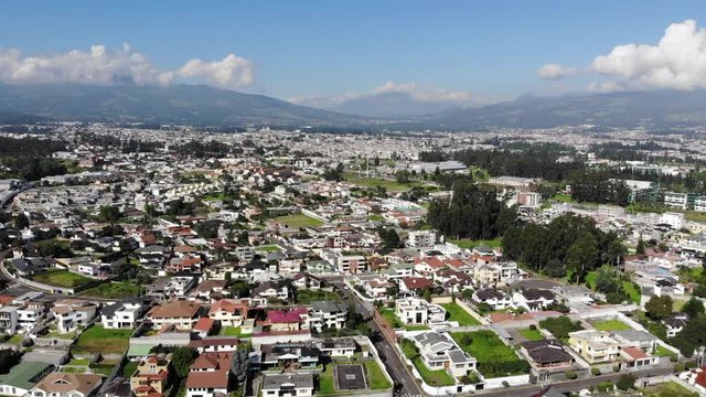 Aerial view over a suburb of Quito, Ecuador, the Valle de Los Chillos. Exceptionally clear sky and absence of smog due to lockdown over the  Coronavirus Covid-19 pandemic. 22 April 2020.
