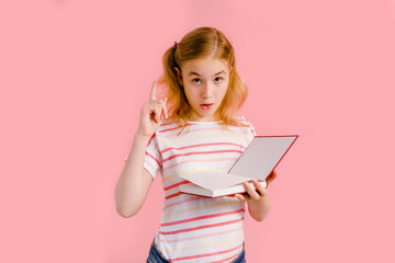 Photo of happy charming blonde girl posing with exercise books and smiling isolated over pink background