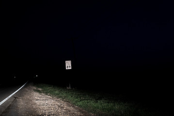 Highway Sign On A Dark Night Road