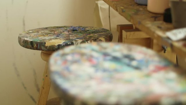 Stools with paint stains in a workshop