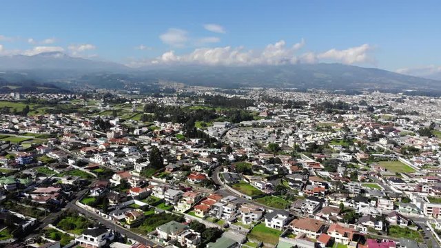 Aerial view over a suburb of Quito, Ecuador, the Valle de Los Chillos. Exceptionally clear sky and absence of smog due to lockdown over the  Coronavirus Covid-19 pandemic. 22 April 2020.