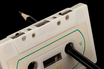 Audio tape with manual rewinding of the film with a pencil