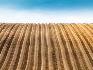 Plowed field view of the mountainous area in the countryside