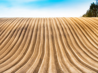 Plowed field view of the mountainous area in the countryside