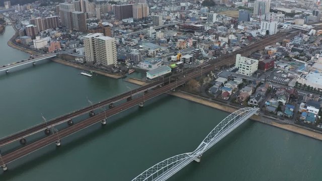 Aerial reveal of bridges leading into Ishiyama in Shiga, Japan.