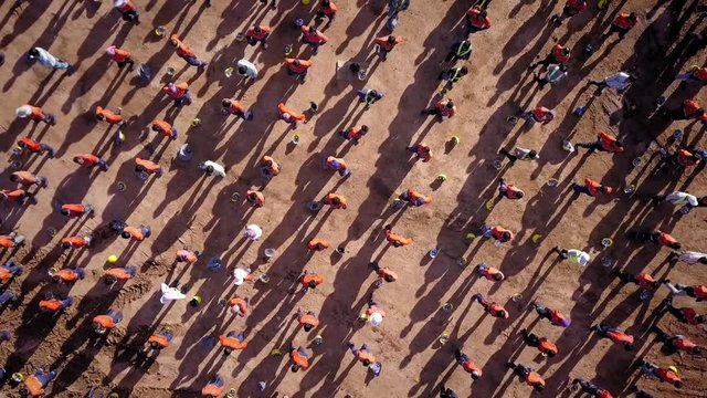 Aerial spinning top down view on workers during morning warm up exercices