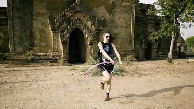4k Women dancing circus temple, stabilizer stady cam hula hoop amazing dance ancient temple beautiful lady tattoos arms background nature
