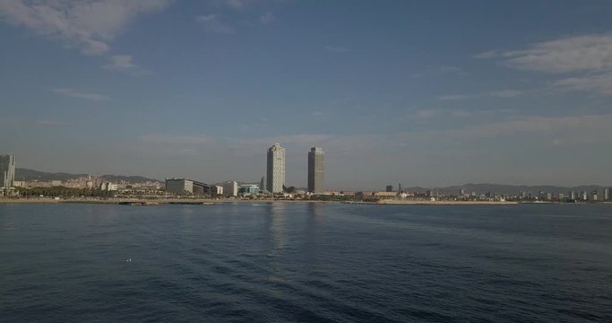 Aerial Dolly towards Barcelona city with Mapfre tower and Port Olimpic