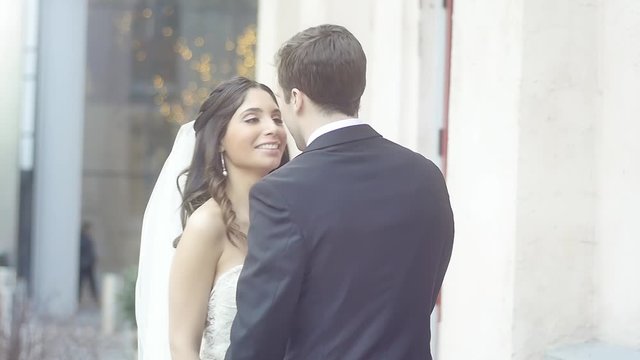 A bride kisses her groom outside of the city church after their wedding