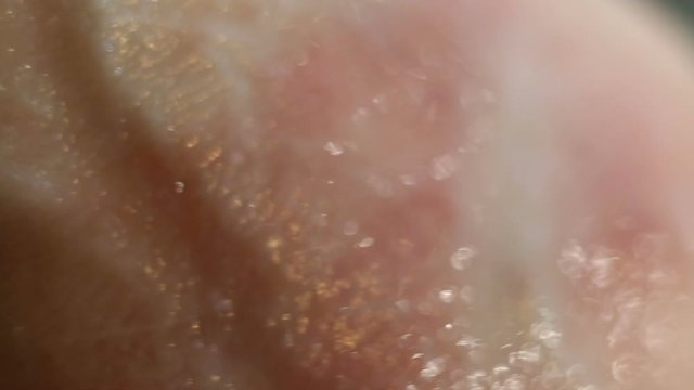 Smear your finger on the skin with a greasy or wet nourishing cream. The skin has obvious problems with the epithelium: red spots, irritation, papules, peeling, eczema. Extreme close-up, real time, co