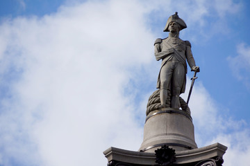 Fototapeta premium Lord Nelson statue close up at Trafalgar square in London with copy space in the sky