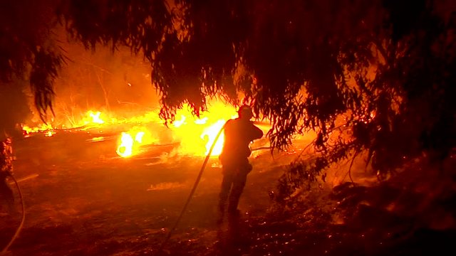 2017 - firefighters work hard to contain brush fires burning out of control during the Thomas Fire in Ventura County, California.