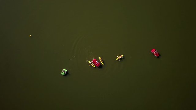 Aerial top down shot of a group of people kayaking and boating on Goldap Lake, Poland