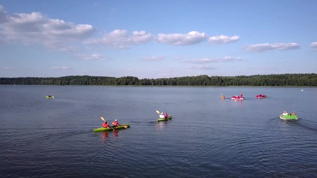 Aerial of a group of tourists kayaking and boating on Goldap Lake, Poland