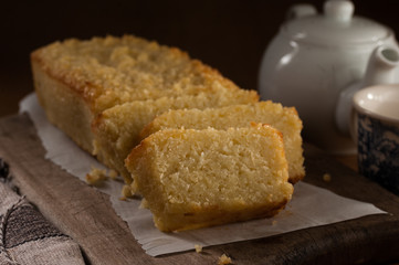 cassava cake slices on a wood table with teapot