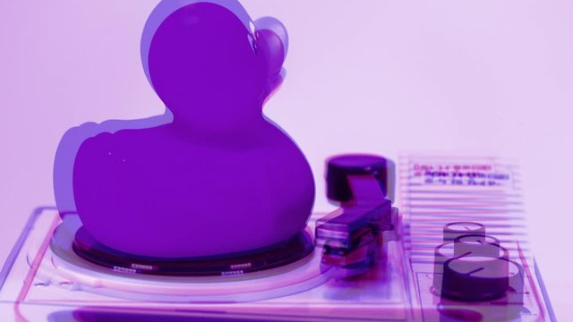 Rubber duck on record player rotating with flashing colours