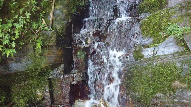 Cascading waterfall flowing downhill in Longji Rice Terraces, Guangxi Province, China