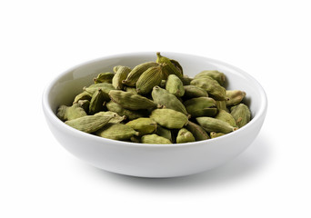 Cardamom seeds in a plate placed on a white background