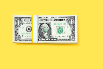 close up of one dollar money bill with face mask on yellow background