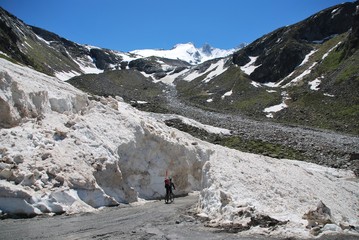 mountain climber descending on mountainbike after skiing Mt. Gabler at Reichenspitz group, Tyrol,...