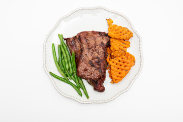 Steak dinner with green beans and sweet potatoes