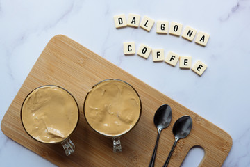 Two glass cups with Dalgona frothy coffee trend korean drink with coffee foam. Iced Dalgona Coffee. Top view