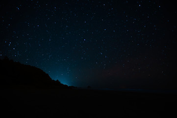 Naklejka premium Night landscape with starry sky. Astrology, space