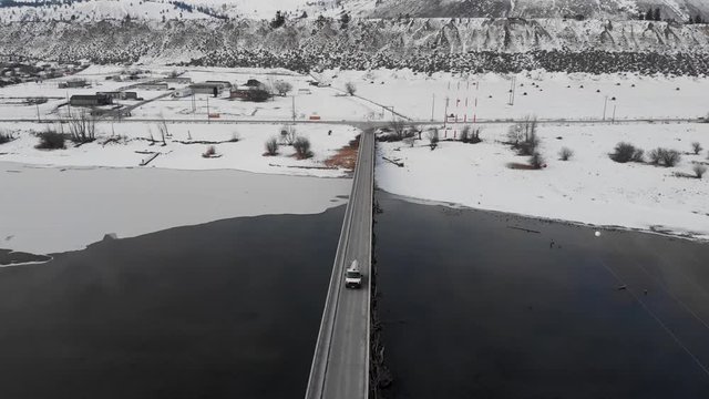 Aerial view of cars crossing the wooden bridge of Pritchard in British Columbia