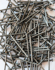 Pile of nails on white isolated background