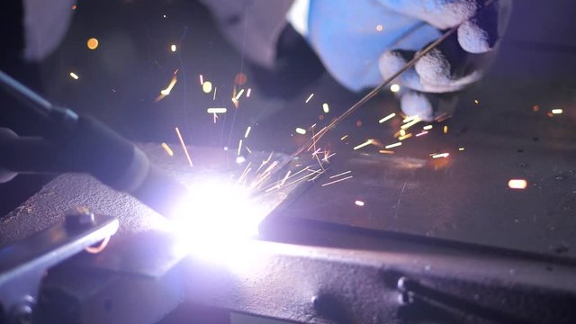 In the workshop. Close-up. Slow motion. Argon-arc welding