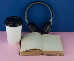 Headphones with open blank book page with copy space. Remote education concept