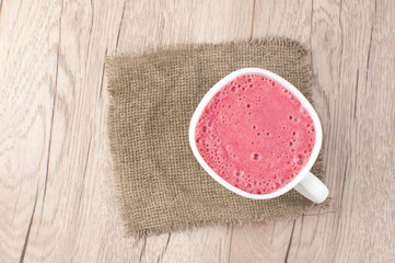Breakfast. Healthy pink smoothie with strawberry in a white ceramic cup with berry. Fitness food.