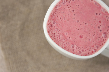Breakfast. Healthy pink smoothie with strawberry in a white ceramic cup with berry. Fitness food.