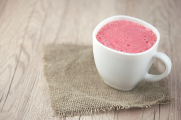 Breakfast. Healthy pink smoothie with strawberry in a white ceramic cup with berry. Fitness food.