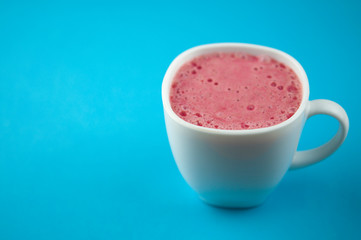 Breakfast. Healthy pink smoothie with strawberry in a white ceramic cup with berry. Fitness food.