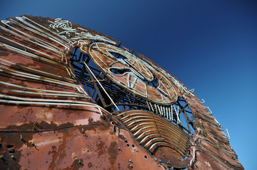 Rusty soviet coat of arms on top of 16-story building in Pripyat