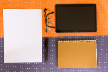 Office concept with tablet, glasses, notebook and sheet