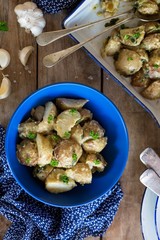 A bowl of Roasted baby potato salad with creamy garlic dressing