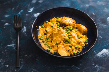 plant-based food, baked potaotes with yellow peas and peas in creamy vegan sauce