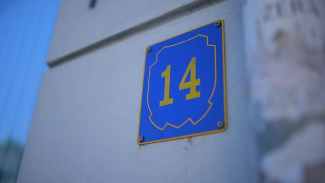 Number fourteen on building, street number 14, sunny day with number fourteen on building