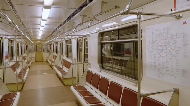Empty row of seats of wagon in moving metro train.