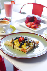 breakfast crepe with bananas and blueberries and pineapple