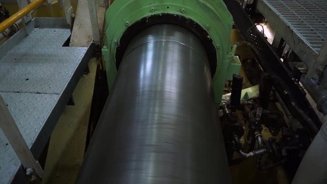 Rotating shaft line of main propulsion plant of passenger ship with intermediate bearings, sensors and pipe lines. Shaft is a link between engine and propeller which is used for ship moving