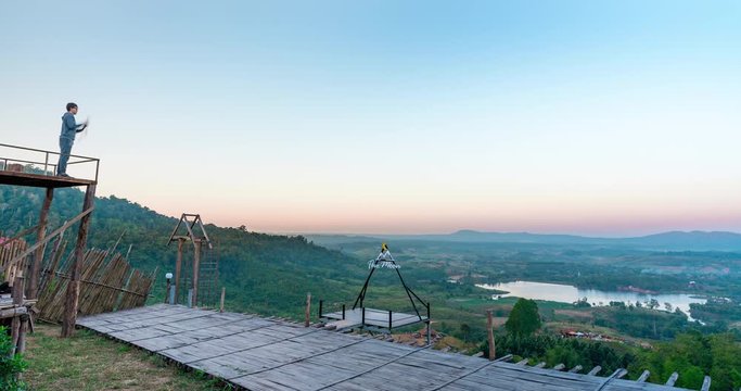 High view Time lapse Landscape Sunrise with mountain, hill with trees, blue sky with mist.