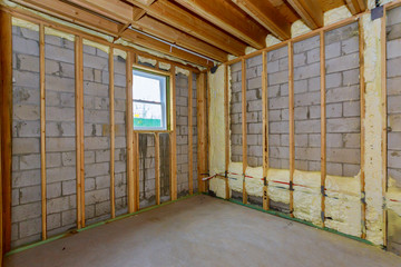 House in unfinished under construction insulation foam the wall of a basement