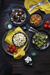 Salad Bar with Bowls of various salads  on wooden table 