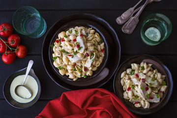 Two Bowls of creamy pasta salad  with chicken and parsley 